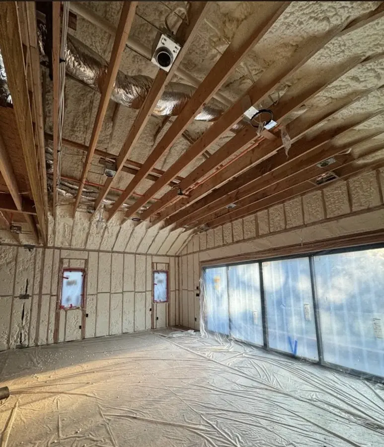 Interior walls and ceiling insulated with spray foam during new construction in Halls